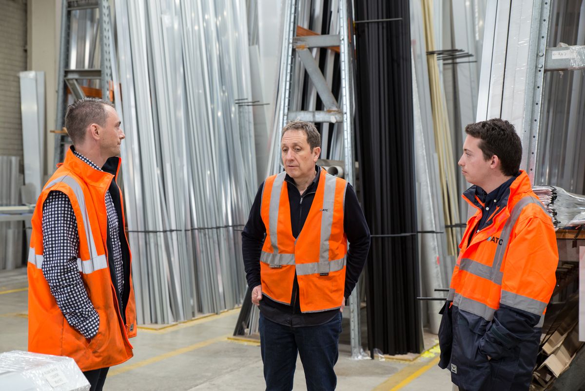 A small business team meeting on the shop floor — where operational decisions actually get made